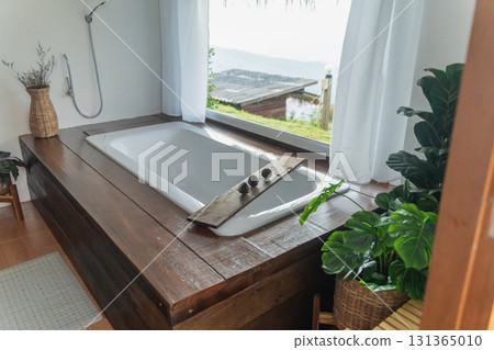 Tranquil Spa Bathroom with Scenic View Overlooking Water, Elegant Bathtub Design, Natural Decor and Relaxing Atmosphere for Wellness Retreat Tranquil Spa Bathroom with Scenic View Overlooking Water, Elegant Bathtub Design, Natural Decor and Relaxing Atmosphere for Wellness Retreat 131365010