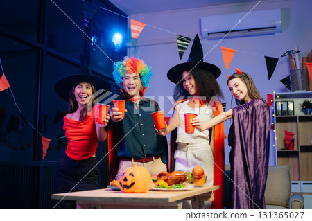 Joyful office Halloween party with coworkers in costumes, celebrating with drinks and laughter, fostering teamwork Joyful office Halloween party with coworkers in costumes, celebrating with drinks and laughter, fostering teamwork 131365027