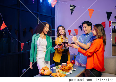 Celebration with friends enjoying food, drinks, and laughter at a lively house party. 131365178