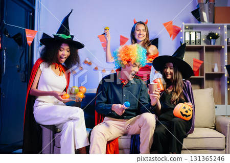 Joyful office Halloween party with coworkers in costumes, celebrating Joyful office Halloween party with coworkers in costumes, celebrating 131365246
