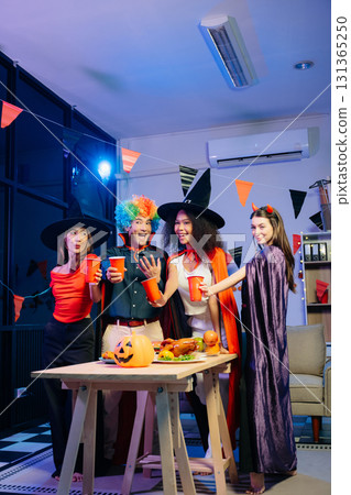 Joyful office Halloween party with coworkers in costumes, celebrating Joyful office Halloween party with coworkers in costumes, celebrating 131365250