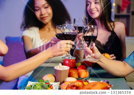 A diverse group of coworkers enjoying a casual office party or home with drinks, food, A diverse group of coworkers enjoying a casual office party or home with drinks, food, 131365359