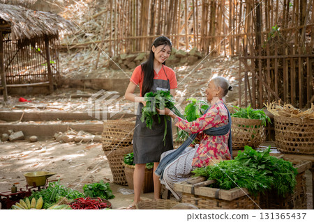 A lively market with fresh herbs, creating connections and joy within the community 131365437
