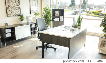 Clean and organized office with a desk, chair, and potted plants 131365882