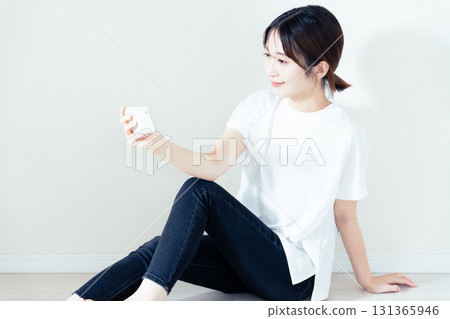 A woman using a smartphone 131365946