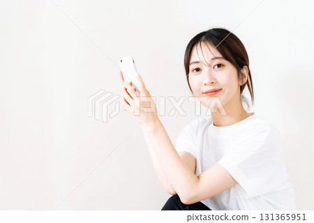 A woman using a smartphone 131365951