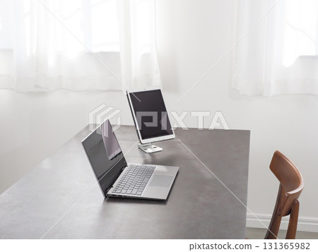 Laptop and tablet on a desk 131365982