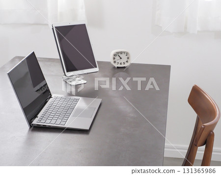 Laptop and tablet on a desk Laptop and tablet on a desk 131365986