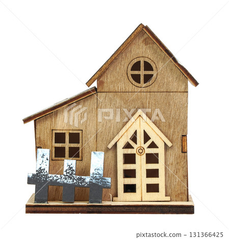 Small decorative wooden house model with pitched roofs isolated on white background 131366425