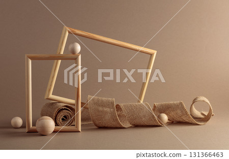 Wooden frames and burlap ribbon on beige background. Wooden frames and burlap ribbon on beige background. 131366463