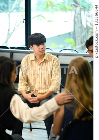 People attending a group therapy meeting, showing empathy and encouragement during psychological session 131366644