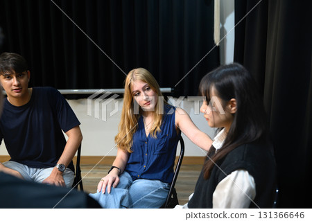 Young woman comforting another participant during a psychotherapy group session Young woman comforting another participant during a psychotherapy group session 131366646