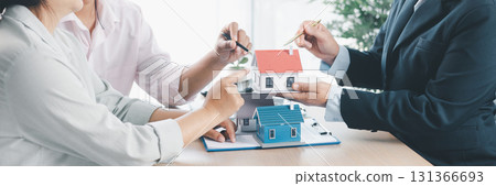 Panorama view of business meeting with miniature house model on desk, real estate contract signing, property investment, mortgage loan agreement and financial planning concept. mortgage loan agreement 131366693