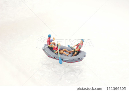 Miniature Figures In A Tiny Boat On Icy Snow Surface 131366805