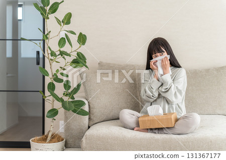 Young Asian woman blowing her nose with hay fever, rhinitis (cedar pollen, cypress pollen, allergic rhinitis) 131367177