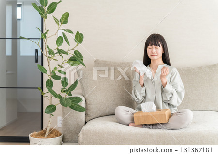 Young Asian woman blowing her nose with hay fever, rhinitis (cedar pollen, cypress pollen, allergic rhinitis) Young Asian woman blowing her nose with hay fever, rhinitis (cedar pollen, cypress pollen, allergic rhinitis) 131367181