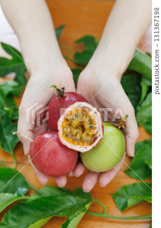 Hand holding passion fruit Hand holding passion fruit 131367198