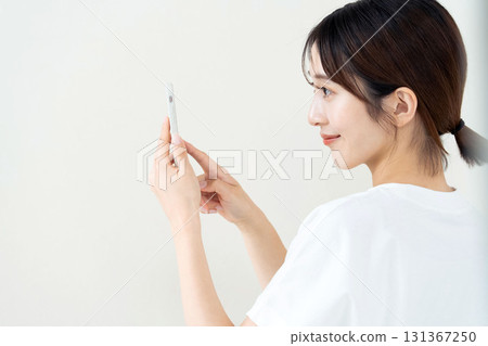 A woman using a smartphone 131367250
