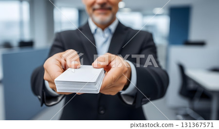 Businessman offers a stack of blank cards, closeup shot Businessman offers a stack of blank cards, closeup shot 131367571