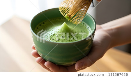 Preparing traditional Japanese matcha tea with bamboo whisk in bowl. 131367636