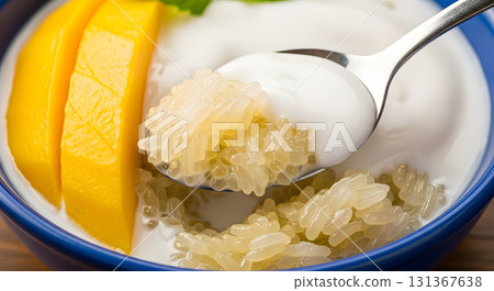 Mango sticky rice dessert with coconut milk in bowl. 131367638