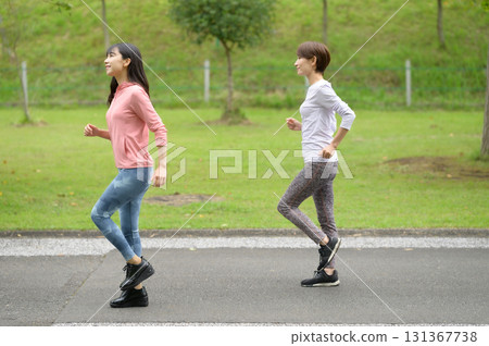 Two women running in the park Two women running in the park 131367738