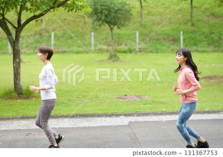 Two women running in the park Two women running in the park 131367753