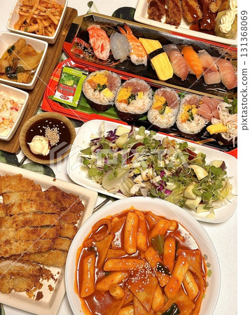 A variety of delicious Korean street food, bunsik includes snacks like tteokbokki, odeng, and hotteok, offering a flavorful mix of spicy, savory, and sweet tastes in every bite. A variety of delicious Korean street food, bunsik includes snacks like tteokbokki, odeng, and hotteok, offering a flavorful mix of spicy, savory, and sweet tastes in every bite. 131368069