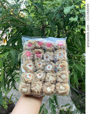 Frozen dimsum ready to steam or fry, filled with savory meat or vegetables, offering a perfect balance of convenience and authentic flavor in every bite. ideal for easy, delicious meals at home. 131368099