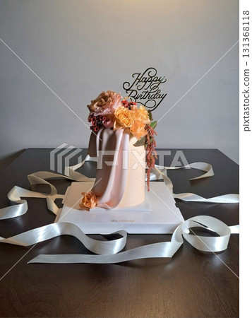 Elegant cake topped with delicate edible flower decorations, offering a perfect blend of soft, sweet layers and natural floral beauty in every slice ideal for celebrations and special moments. 131368118