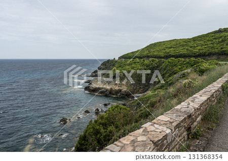 Coastline view Roadtrip Winding road along rocky coast of Cap Corse peninsula on Corsica island France Coastline view Roadtrip Winding road along rocky coast of Cap Corse peninsula on Corsica island France 131368354