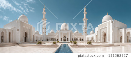 Grand white mosque with domes and minarets blue sky, reflecting pool courtyard, showcasing intricate Islamic architecture and serene atmosphere 131368527