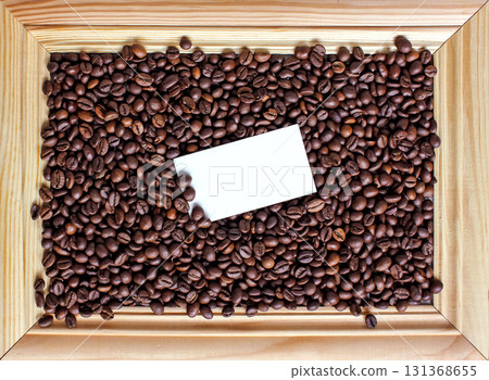 Close up coffee background. Heap roasted coffee beans spread over on table on four side on white background. Copy space. Top view. Place for text. View from above. 131368655