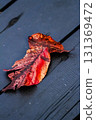 Bright red fallen leaves on the wooden deck 131369472