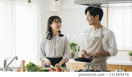 A couple cooking together in the kitchen 131369476
