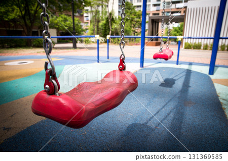 Swings and scenery at the apartment playground 131369585