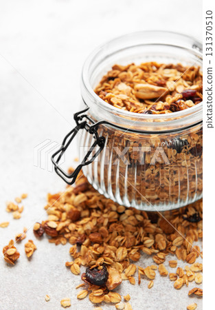 Granola cereal in glass jar for healthy breakfast Granola cereal in glass jar for healthy breakfast 131370510