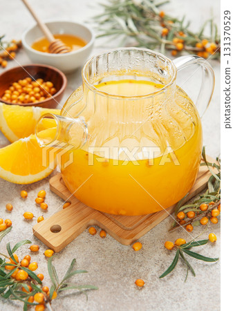 Warming sea buckthorn tea with orange slices and honey Warming sea buckthorn tea with orange slices and honey 131370529