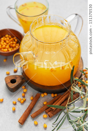 Sea buckthorn tea in teapot with cinnamon and berries Sea buckthorn tea in teapot with cinnamon and berries 131370530