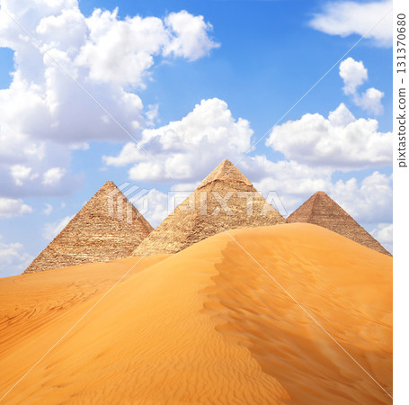 Famous Great Pyramids of Menkaure, Chephren and Cheops, Cairo, Egypt. Three iconic Great Pyramids and beautiful sand dunes, Giza Necropolis, have become a popular destination for travellers 131370680