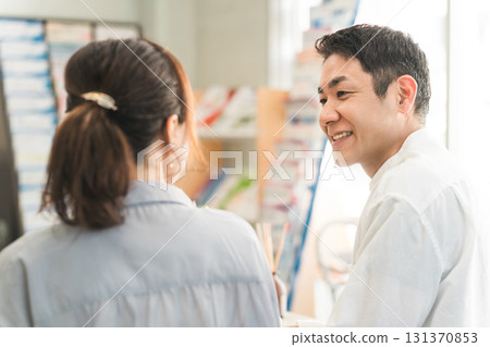 A couple listening to a discussion in the showroom/negotiation space A couple listening to a discussion in the showroom/negotiation space 131370853