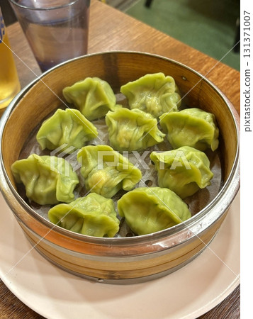 Korean dumplings filled with a mix of savory ingredients like ground meat, tofu, and vegetables. Mandu can be steamed, boiled, or pan-fried, making it a versatile and delicious snack or meal. 131371007
