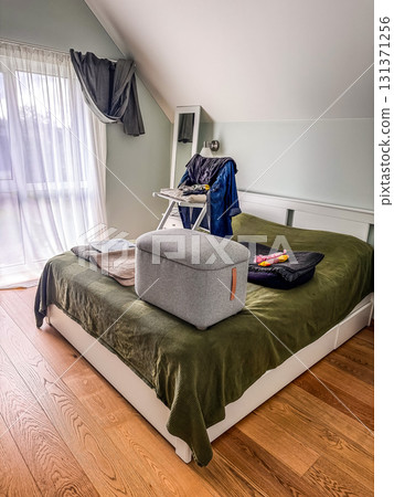 cleaning Cozy Bedroom Interior with Green Blanket and Wooden Floor. High quality photo 131371256