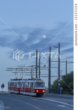 Tram travelling under half moon in Prague, Czechia 131371324