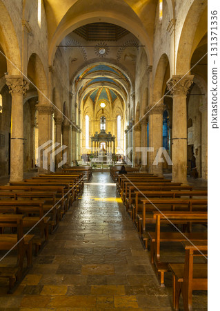 Massa Marittima cathedral interior exhibiting Romanesque architecture and nave 131371336