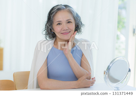Senior woman doing skin care Senior woman doing skin care 131371449