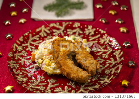 Traditional Christmas dinner with golden fried fish and potato salad 131371665