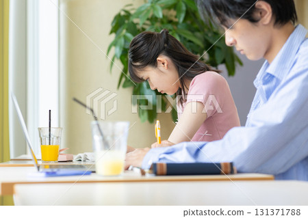 Hands of a university student studying in a cafeteria 131371788