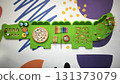 Interactive wall-mounted sensory play panel for kids, shaped like a crocodile, featuring gears, mazes, musical instruments, and bead games for hands-on learning and fun.  131373079