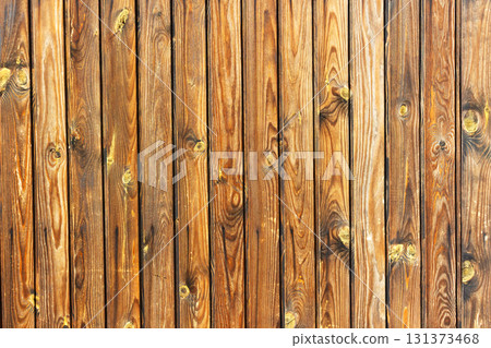 Closeup texture of wooden planks with natural grain, knots, and warm brown tones. Rustic wood background suitable for design, carpentry, construction, and decorative use Closeup texture of wooden planks with natural grain, knots, and warm brown tones. Rustic wood background suitable for design, carpentry, construction, and decorative use 131373468